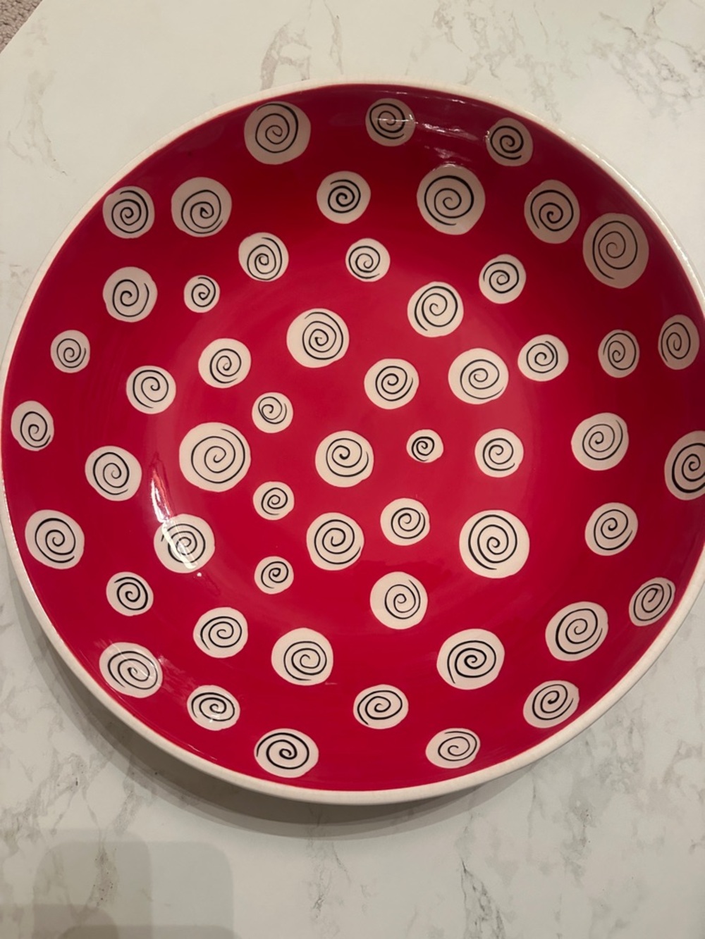 Like new. Large serving bowl All U Can Handle. Red and black swirl pattern